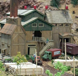 Stacks of rough lumber at a mirror image, scratch built copy of the Master Creations Coon Gap Sawmill