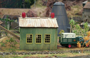 Sawmill scene with sawdust and ground cover